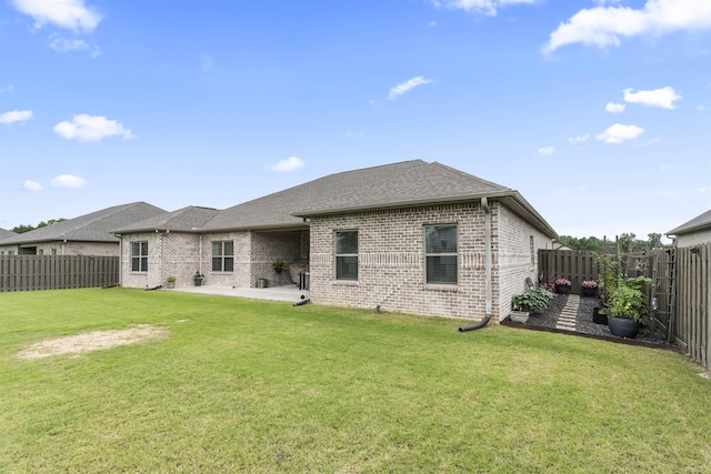  - rear view of house featuring brick siding, a patio, and roof with shingles