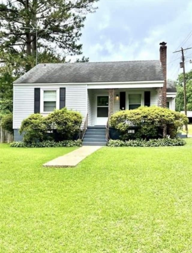 view of front of property with a porch and a front yard