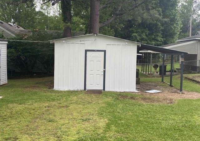 view of outbuilding featuring a lawn