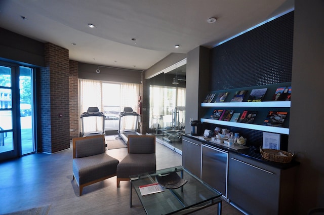 bar with fridge and wood finished floors