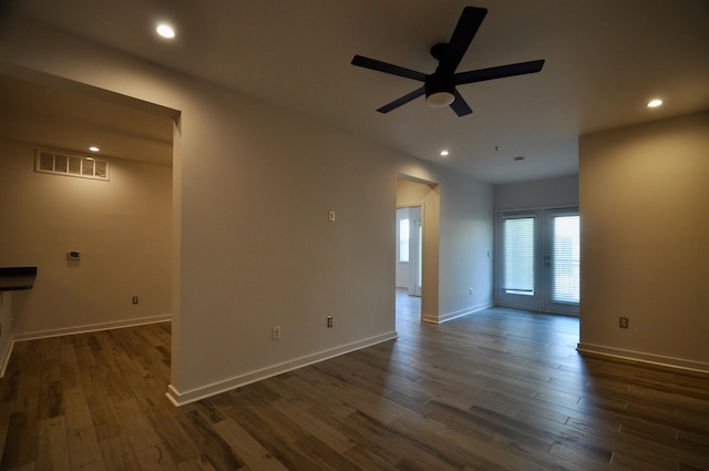 empty room with recessed lighting, visible vents, dark wood-style flooring, and baseboards