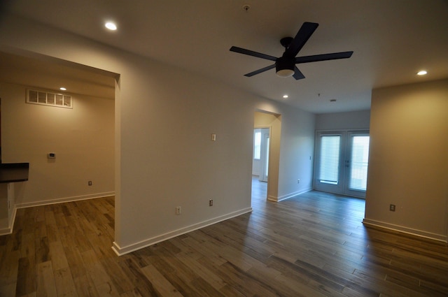 empty room featuring dark wood-type flooring, recessed lighting, and visible vents