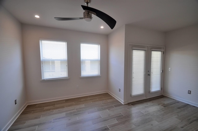 unfurnished room with recessed lighting, baseboards, and wood finished floors