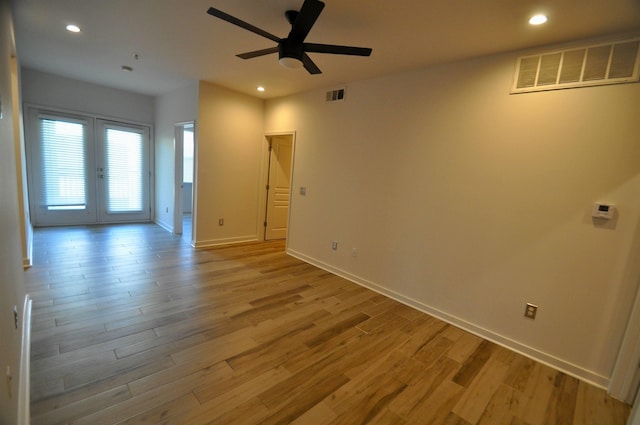 empty room featuring light wood-style flooring, recessed lighting, and visible vents