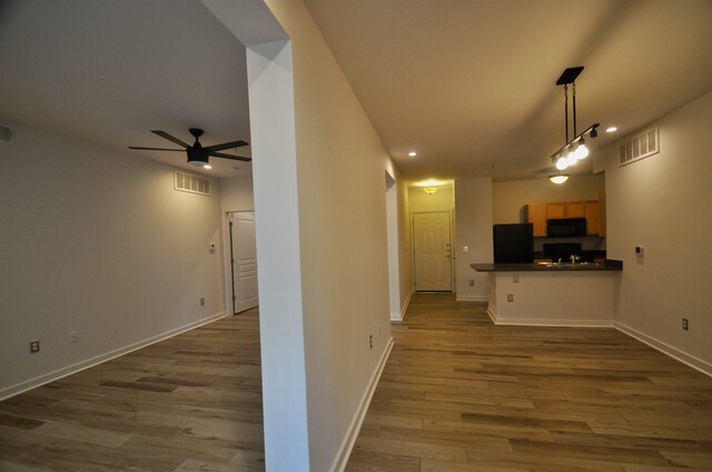 kitchen with visible vents, dark countertops, black appliances, and open floor plan