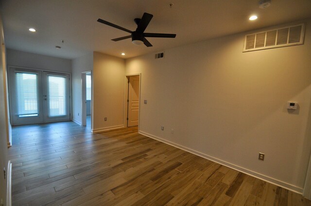 unfurnished room featuring recessed lighting, wood finished floors, and visible vents