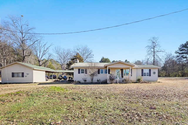 ranch-style home with a front lawn and a carport