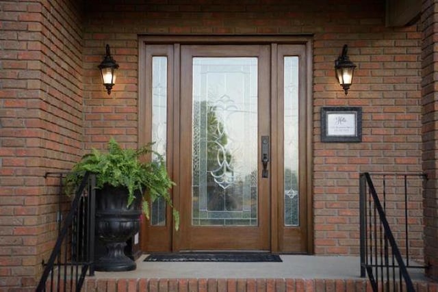  - property entrance featuring brick siding