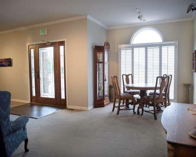  - foyer featuring carpet flooring, ornamental molding, and baseboards