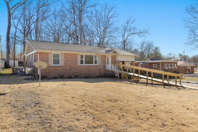 ranch-style home with brick siding and a wooden deck