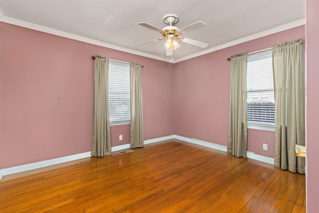 spare room with hardwood / wood-style flooring, ceiling fan, baseboards, and ornamental molding