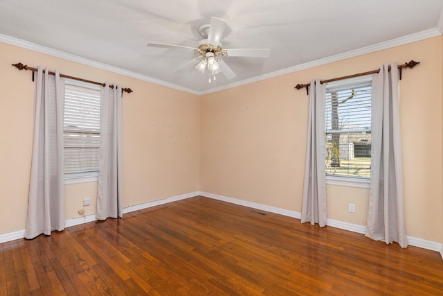 empty room with ornamental molding, dark wood finished floors, a ceiling fan, and baseboards