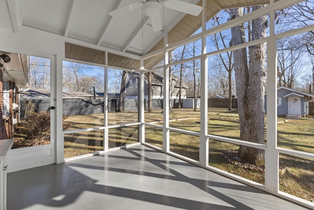 unfurnished sunroom with lofted ceiling with beams and ceiling fan