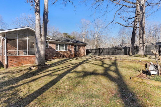 view of yard with a sunroom and fence