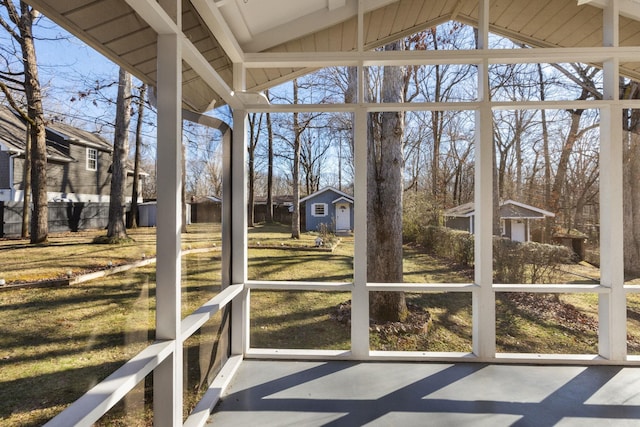 unfurnished sunroom featuring vaulted ceiling