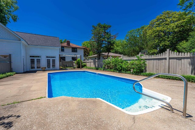  - view of swimming pool with french doors and a patio
