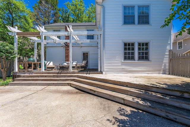  - back of house with a wooden deck, a pergola, an outdoor living space, and a patio area