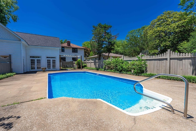  - view of swimming pool with french doors and a patio