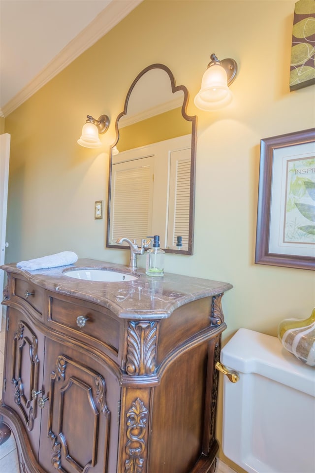  - bathroom with vanity, toilet, and crown molding