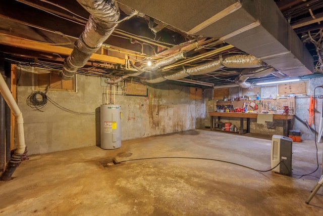  - basement with electric water heater and a workshop area