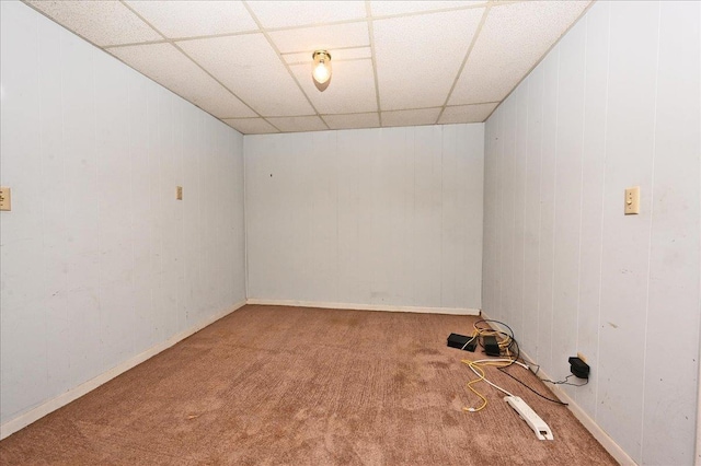 spare room with carpet and a drop ceiling