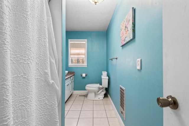 bathroom with vanity, a textured ceiling, tile patterned floors, and toilet