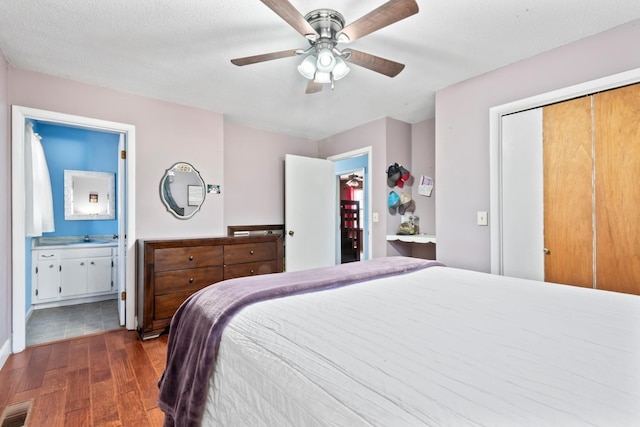 bedroom featuring ensuite bathroom, sink, ceiling fan, dark hardwood / wood-style floors, and a closet