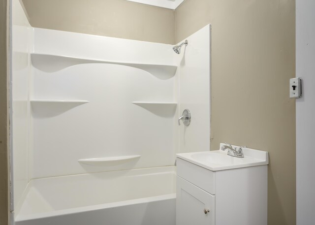 bathroom featuring shower / tub combination and vanity