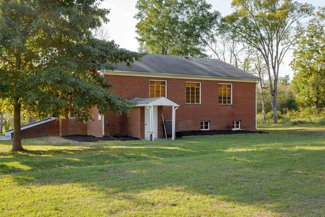 rear view of house with a yard