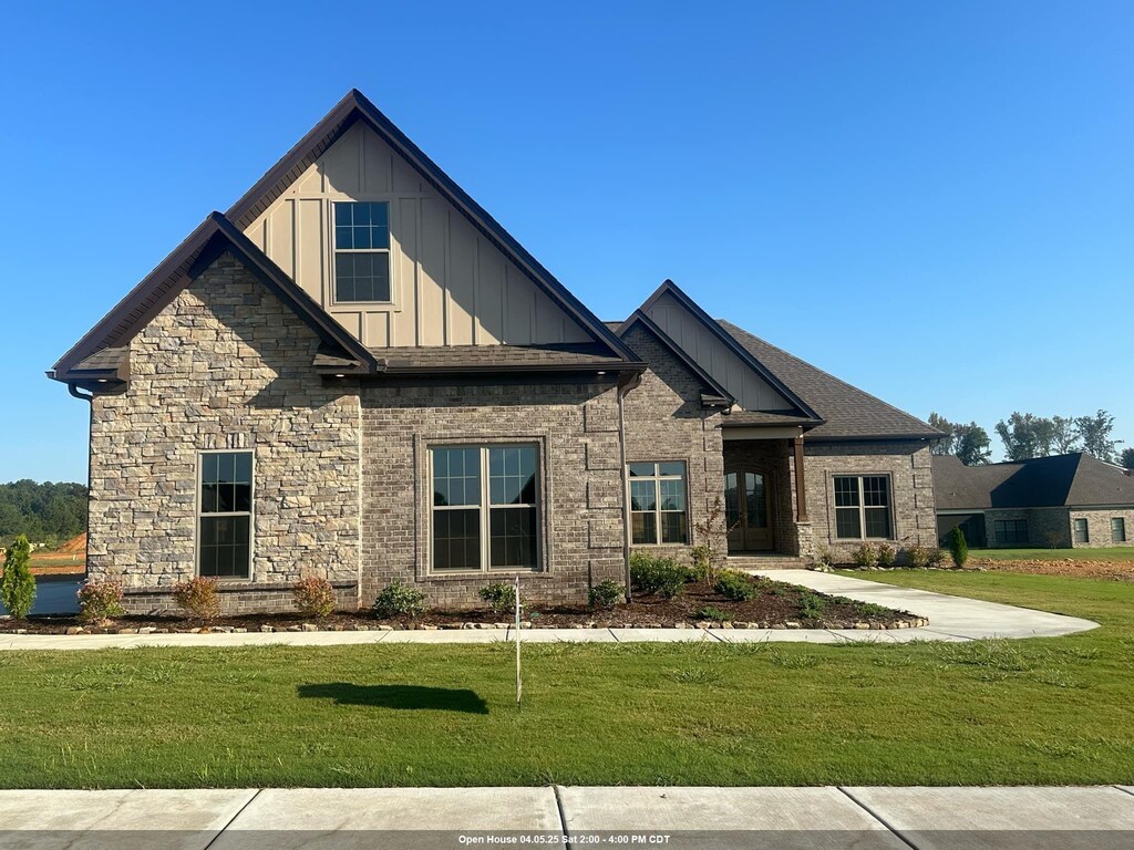 craftsman-style house with board and batten siding and a front lawn