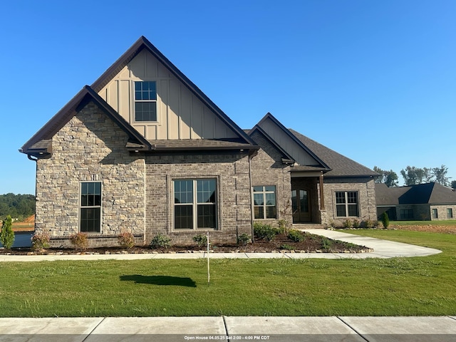 craftsman-style house with board and batten siding and a front lawn