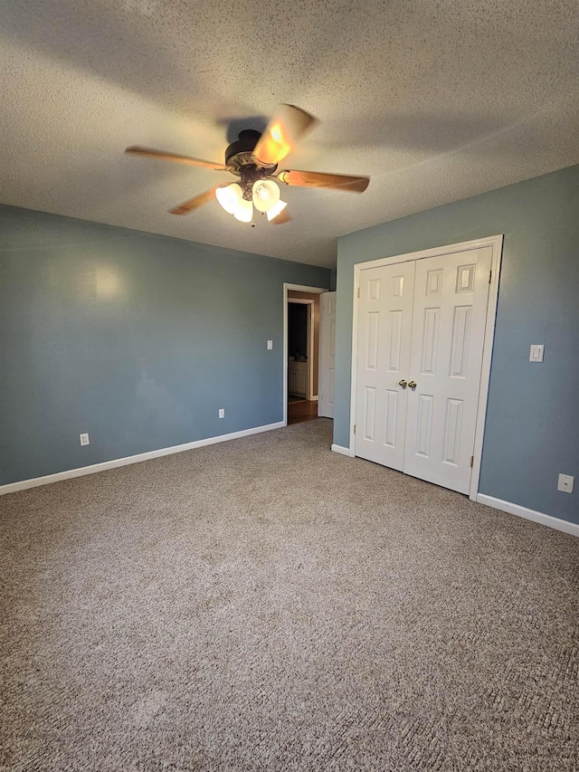 unfurnished bedroom with ceiling fan, carpet, a closet, and a textured ceiling