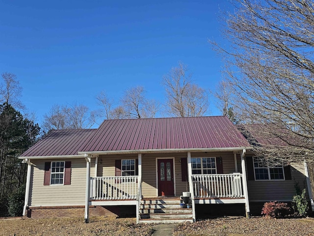 single story home featuring a porch and a playground