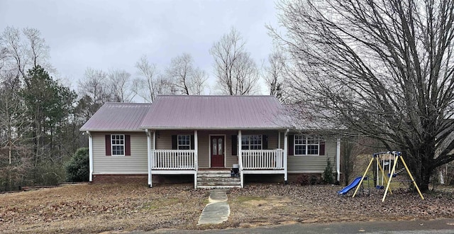 view of front facade featuring a playground and a porch