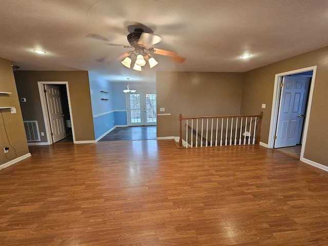 unfurnished room with ceiling fan and wood-type flooring