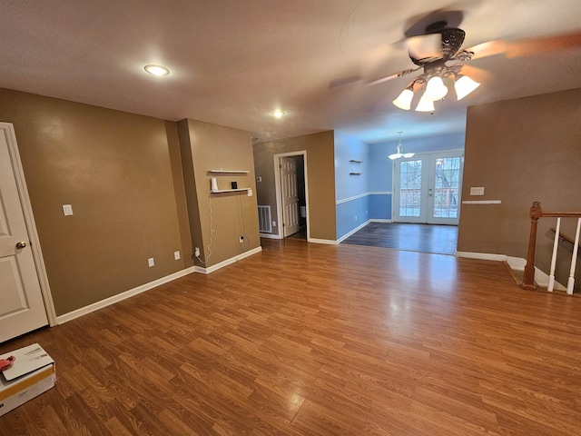 unfurnished living room featuring ceiling fan, wood-type flooring, and french doors