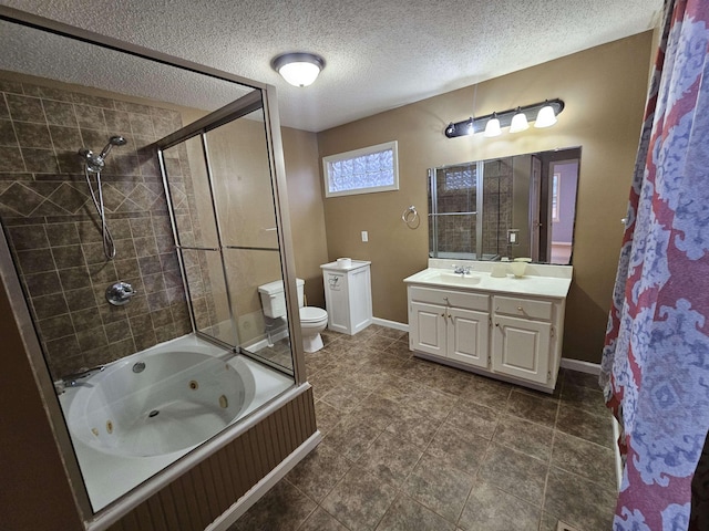 full bathroom featuring toilet, vanity, a textured ceiling, and tiled shower / bath