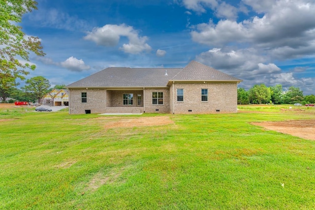 rear view of property with a yard