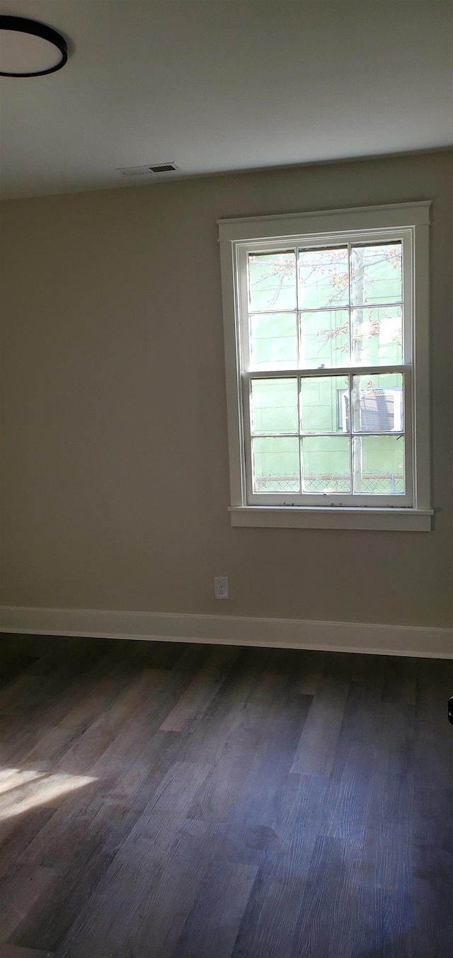 empty room featuring dark hardwood / wood-style flooring