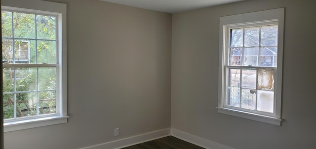 spare room with dark hardwood / wood-style flooring