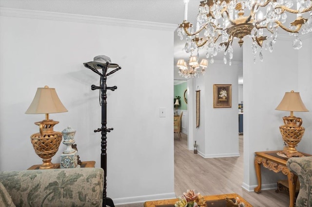 hall with light wood-type flooring, a chandelier, and crown molding