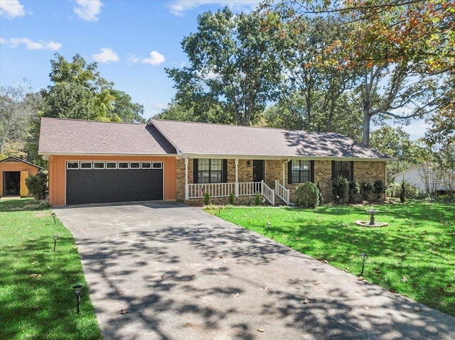 ranch-style house with covered porch, a garage, and a front lawn