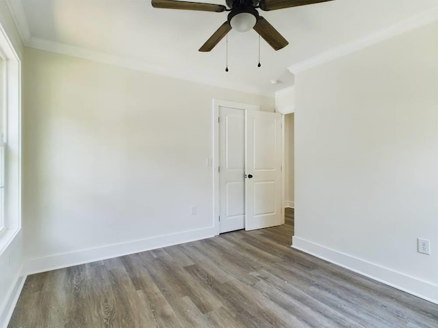 unfurnished room featuring ornamental molding, plenty of natural light, ceiling fan, and light hardwood / wood-style flooring