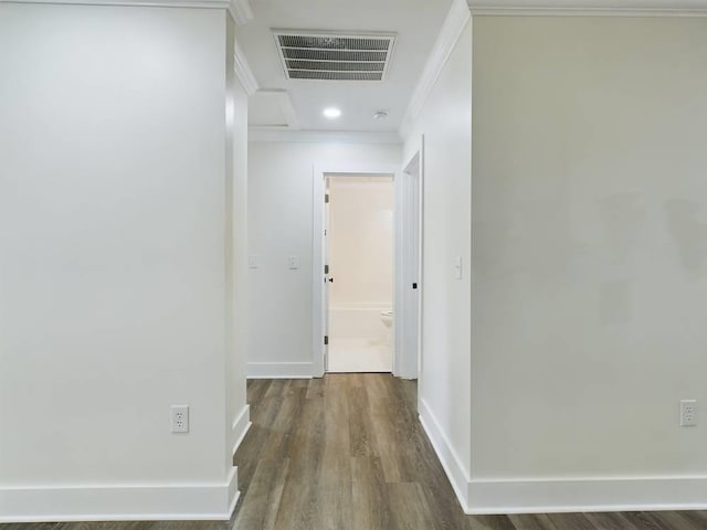 hallway with ornamental molding and dark hardwood / wood-style floors