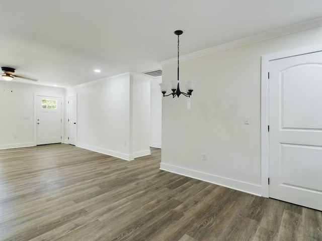 unfurnished dining area featuring hardwood / wood-style flooring, crown molding, and ceiling fan with notable chandelier