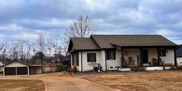 view of front of property with covered porch, an outdoor structure, and a garage