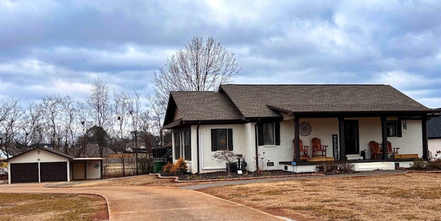 view of front of home with an outbuilding, a porch, and a garage