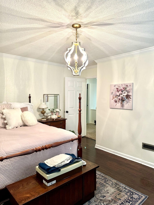 bedroom with crown molding, dark wood-type flooring, a textured ceiling, and an inviting chandelier