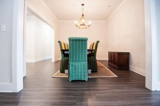 dining space featuring dark hardwood / wood-style floors, crown molding, and a chandelier