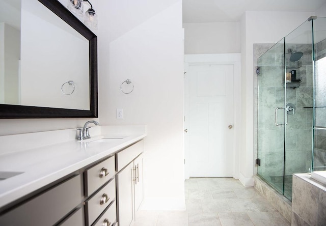 bathroom with tile patterned floors, vanity, and an enclosed shower